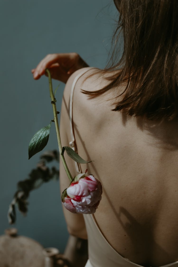 Woman Holding A Flower Behind Her Back 