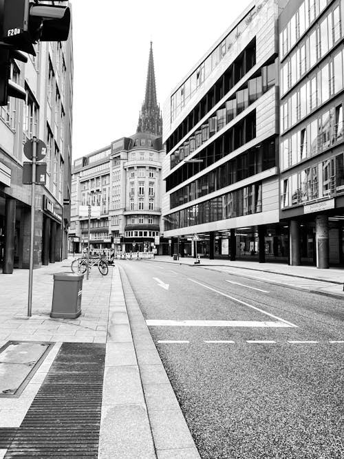 Grayscale Photo of an Empty Street in a City 