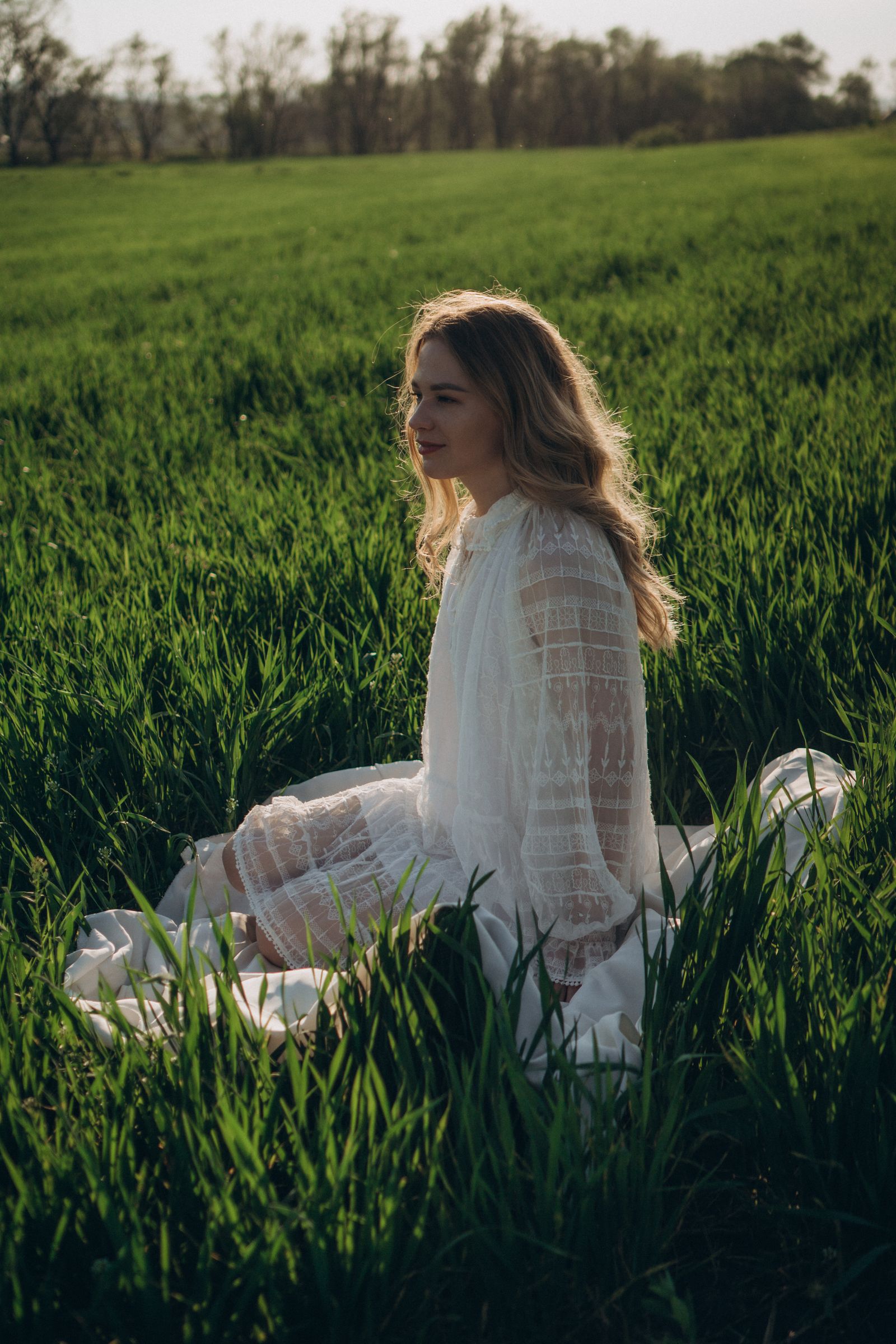 The Boho Dress Edit — woman in a white dress sitting in a green grass field