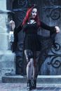 Woman in Black Long Sleeve Dress Holding Black Leather Handbag