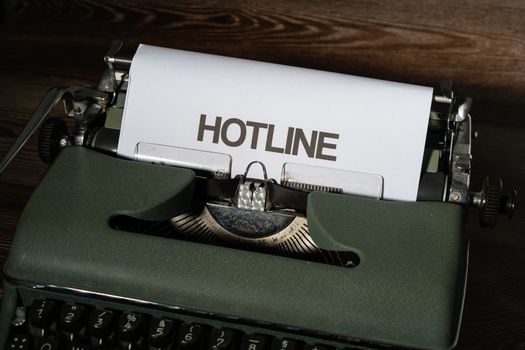 Vintage typewriter with paper labeled 'HOTLINE', showcasing classic correspondence.