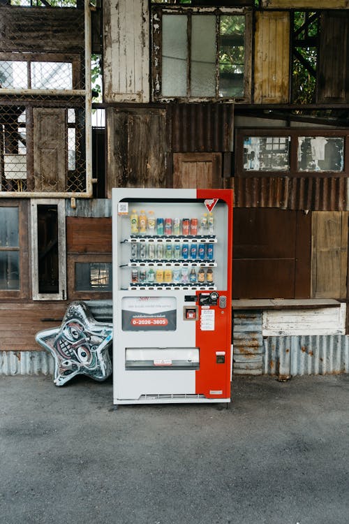 Soda Vending Machine outside an Abandoned Building