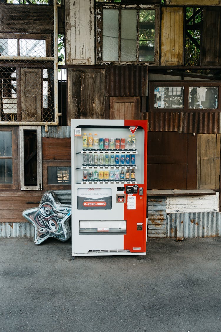 Soda Vending Machine Outside An Abandoned Building