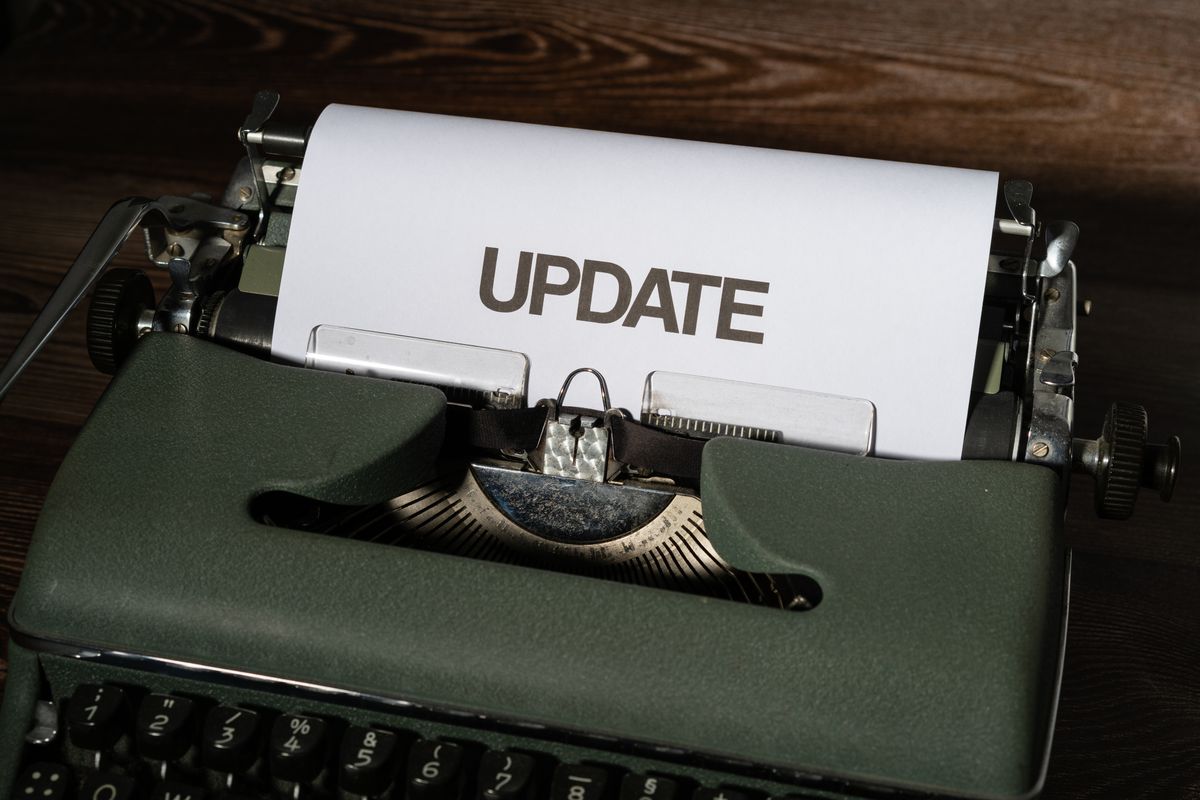 Typewriter with a sheet of paper reading UPDATE