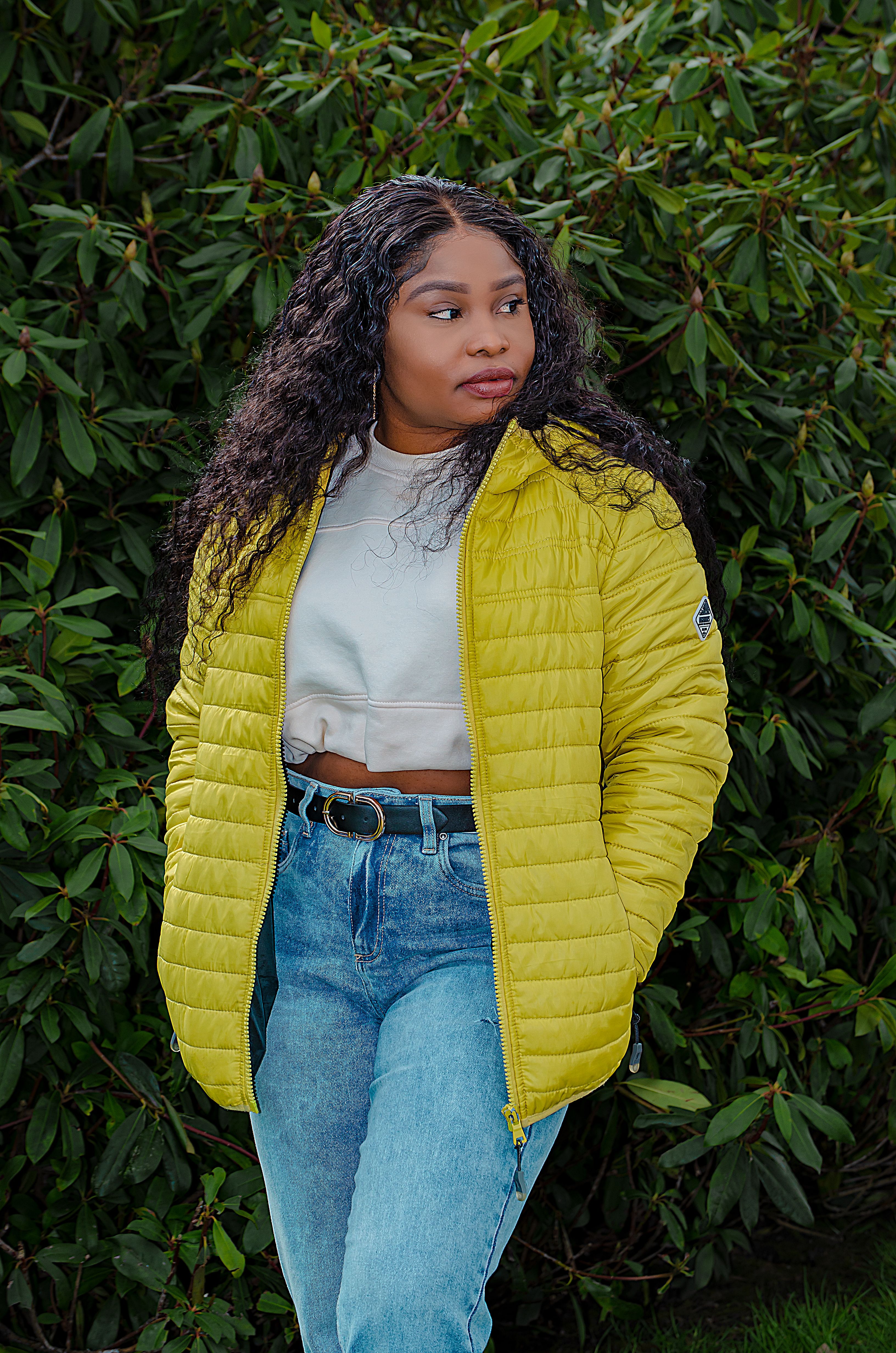 Woman in Yellow Jacket Standing Near Green Plants · Free Stock Photo