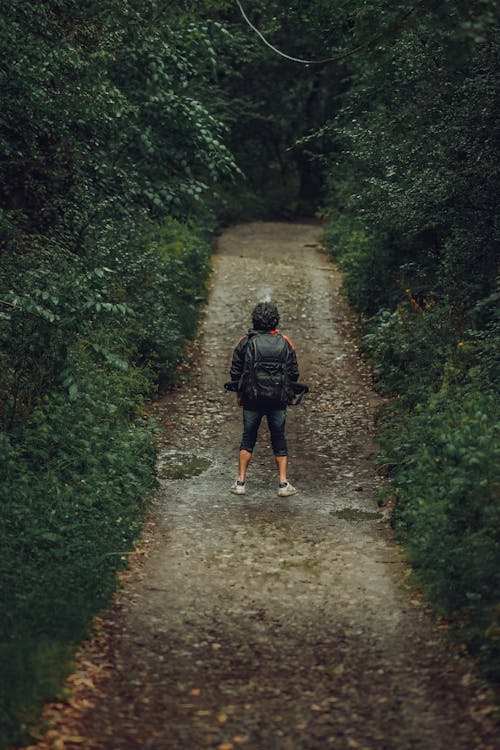 Man standing in an Unpaved Pathway in Tilt-shift Lens