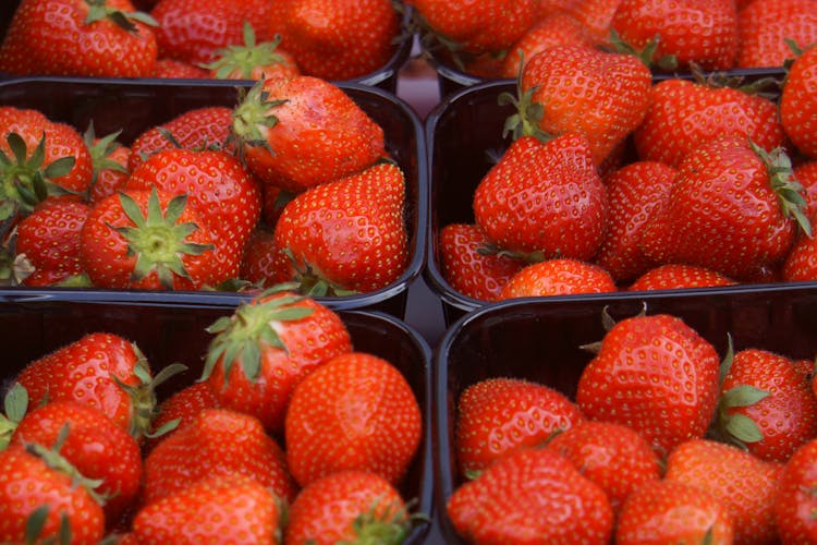 Groups Of Strawberries In Black Containers