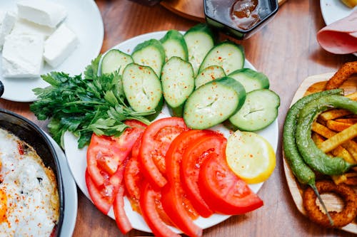 Free A Plate of Sliced Cucumbers and Tomatoes Stock Photo