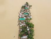 Island Village Surrounded by Murky Water