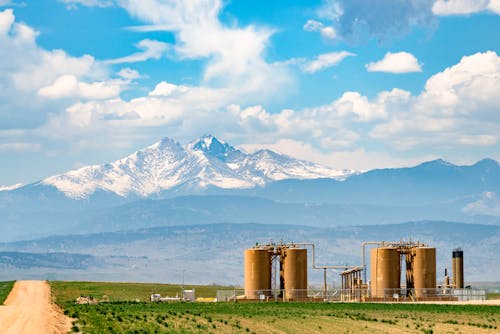 Industrial Plant near Snow Capped Mountains 