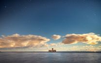 Silhouette of Ship on Sea Under Blue Sky and White Clouds