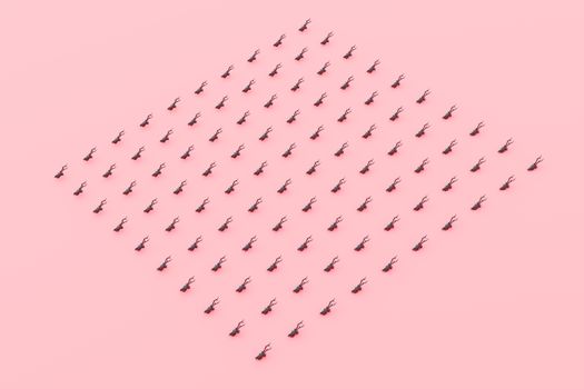 A creative and artistic display of miniature black ants arranged on a pink surface.
