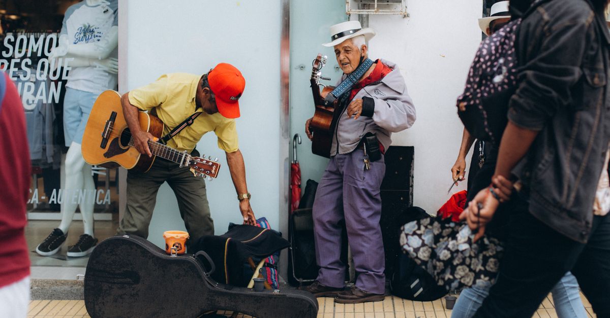 Exhausted musician backstage, slumped over a guitar case, holding a water bottle