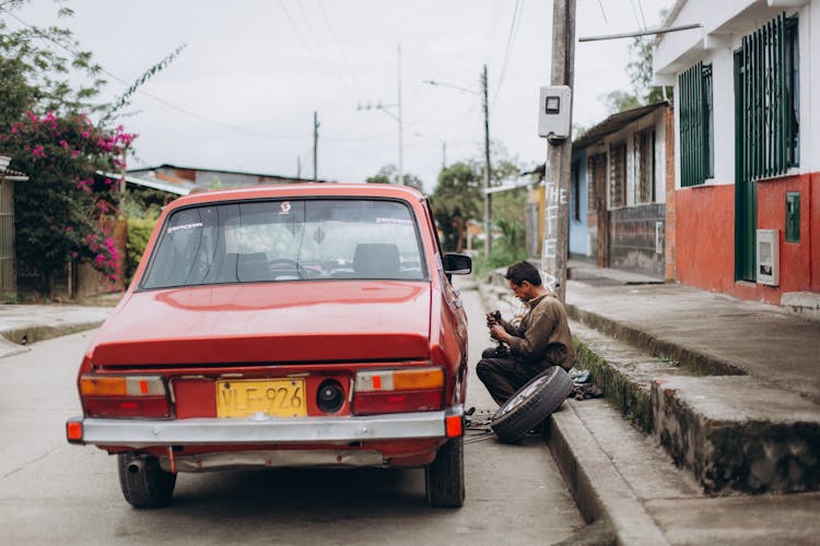 Man Changing A Flat Tire