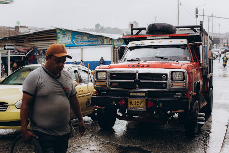 Man Walking In Front Of Truck In Rain