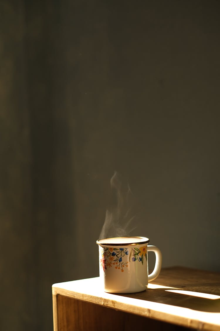 Hot Beverage On The Edge Of A Wooden Table 