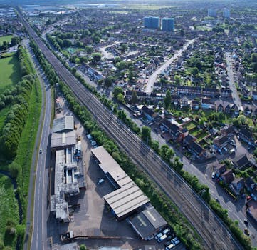 Aerial view of Luton, UK, showcasing urban architecture, roads, and greenery.