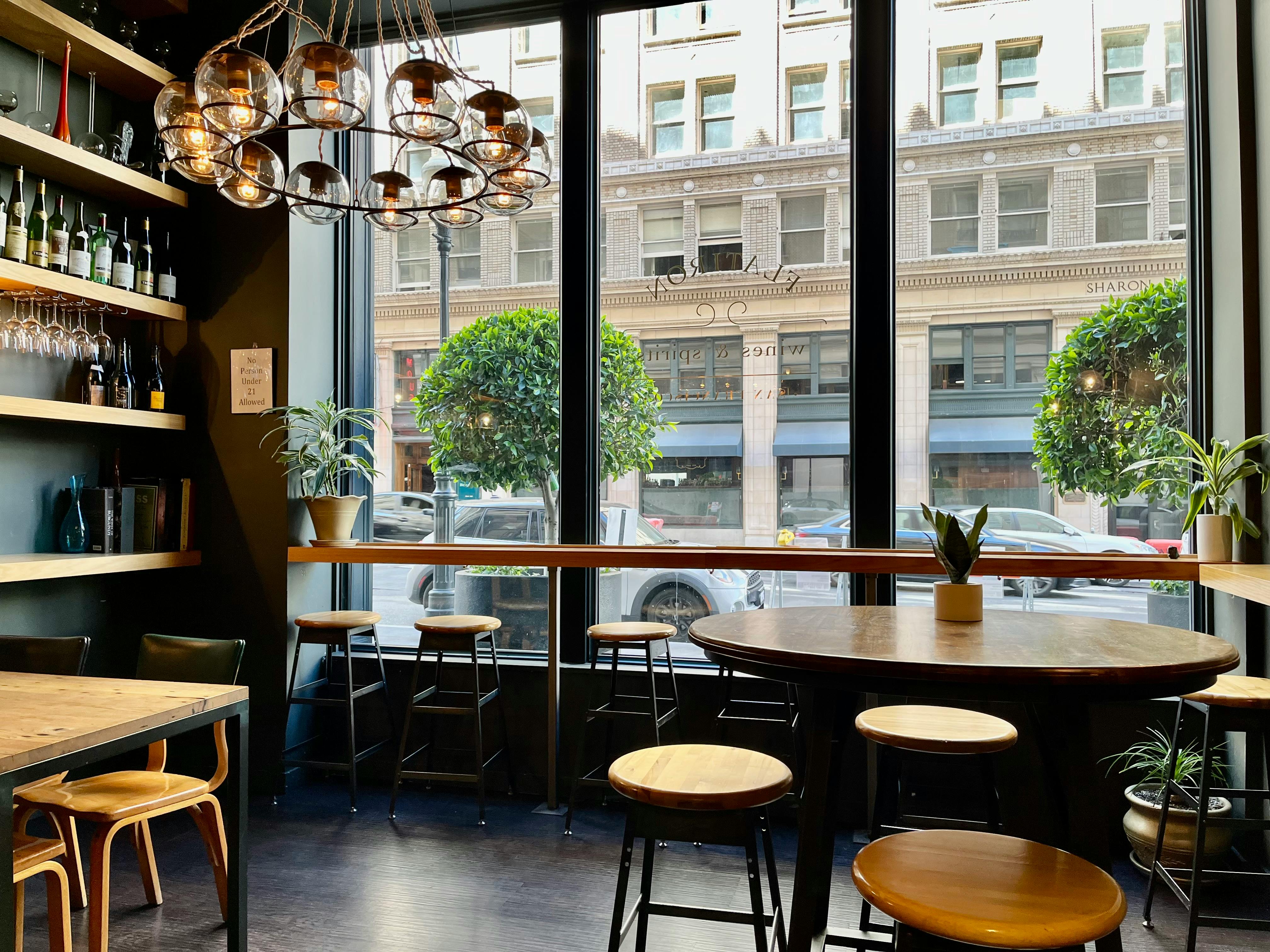 Free Modern cafe interior with large windows showcasing a San Francisco street view. Stock Photo