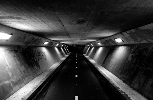 Grayscale Photo of a Tunnel 