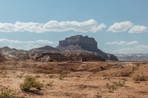 Free A breathtaking view of a desert canyon with stunning rock formations under a clear blue sky. Stock Photo