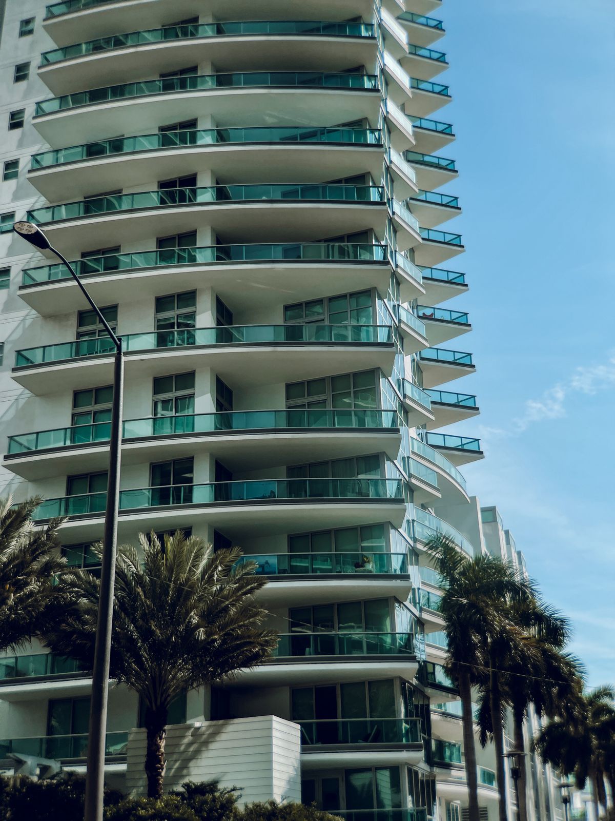 Modern luxury residential apartment tower with glass balconies
