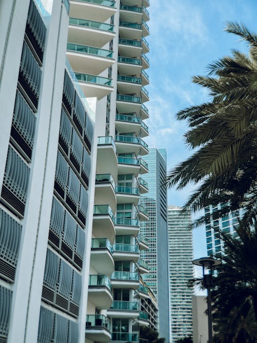 White Concrete Building With Balconies and Metal Railings