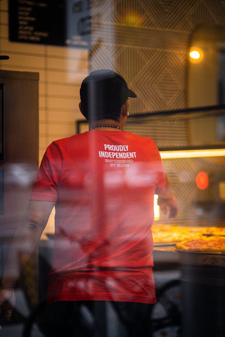 Back View On A Man Baking Pizza