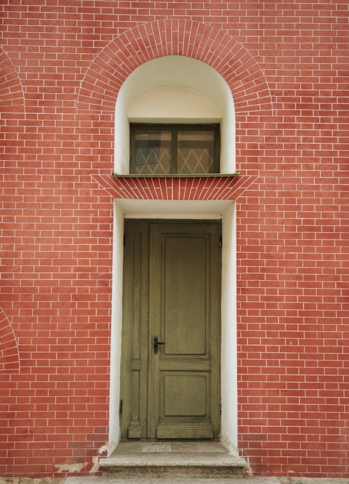 Wooden Door on Red Brick Wall