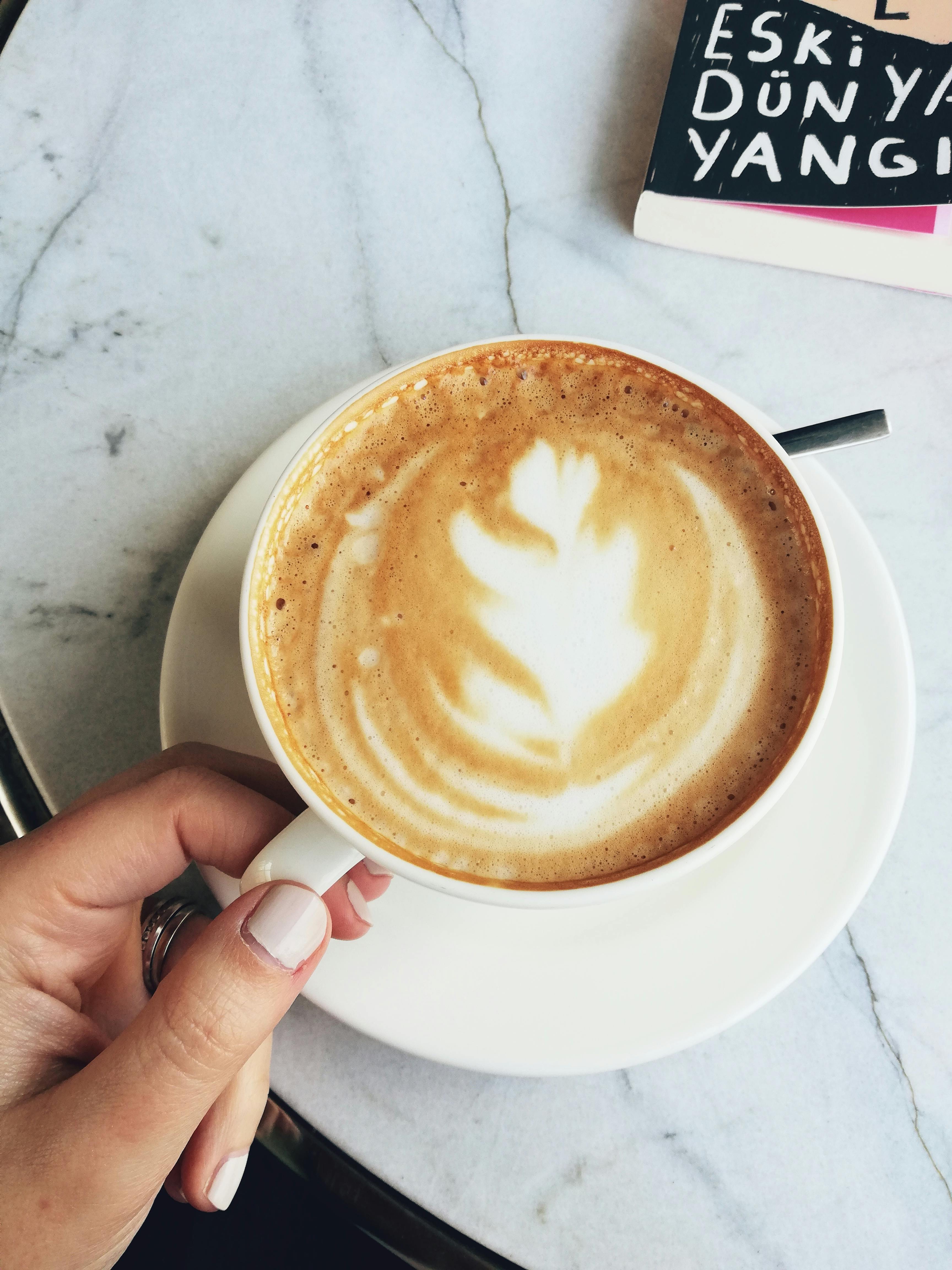 Premium Photo  Two glasses coffee cup with cappuccino in morning on white  table with latte art aroma ristretto mug of coffee glass close up top view  ceramic cup of coffee on