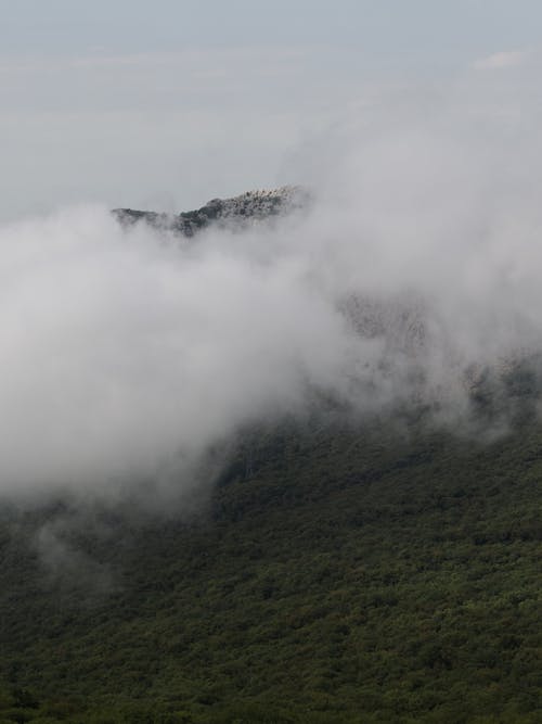 Green Mountain Covered With White Clouds