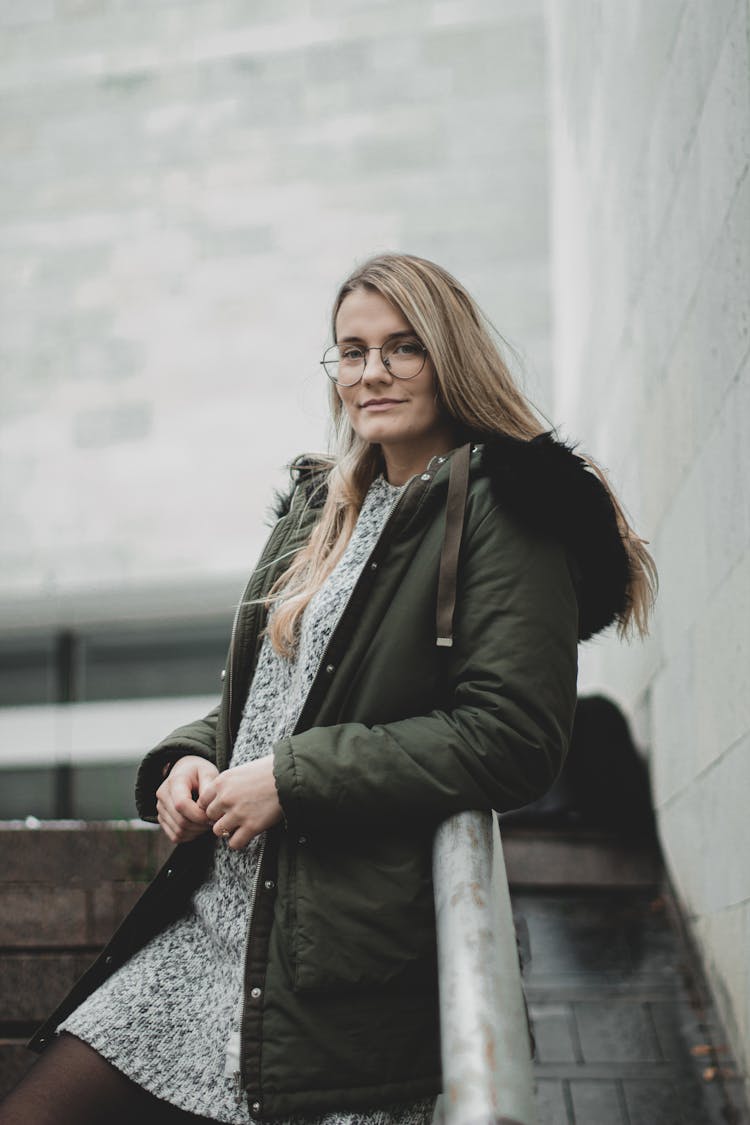 Woman In A Dress And Green Hoodie Jacket 