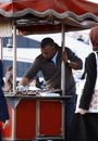 A Man Selling Food on a Food Cart