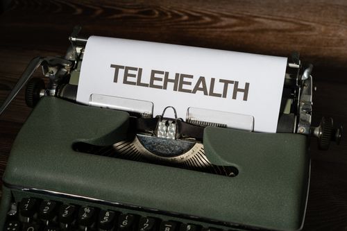 Free A vintage typewriter showcasing the word 'Telehealth' on paper, symbolizing modern healthcare. Stock Photo