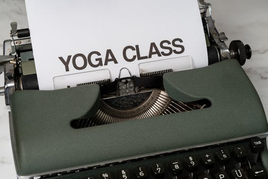 A retro typewriter with a 'Yoga Class' message on white paper, ideal for vintage-themed projects.