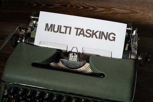 Close-up of a Piece of Paper with a Text "Multi Tasking" in a Vintage Typewriter 