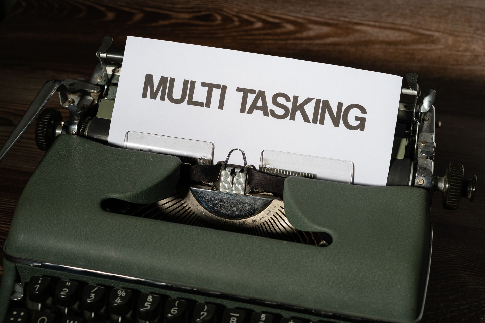 Close-up of a vintage typewriter featuring the word MULTITASKING on paper.
