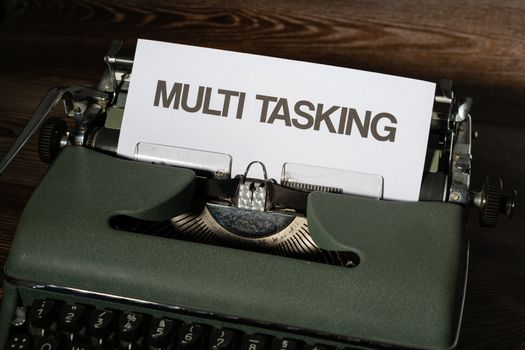 Close-up of a vintage typewriter featuring the word MULTITASKING on paper.