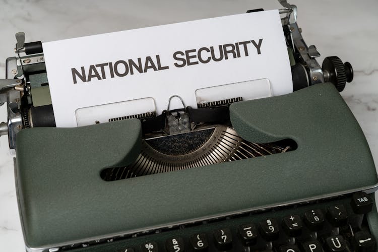 Green And White Typewriter On White Table