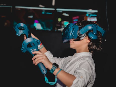 Young boy enjoying virtual reality gaming with VR headset and controllers indoors.