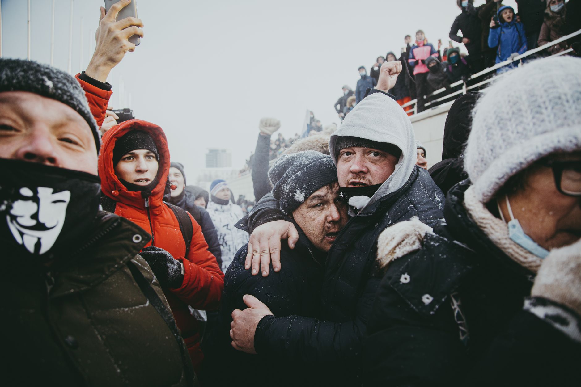 A dynamic street protest scene in winter, showcasing emotions amidst a crowd in Ufa, Russia.