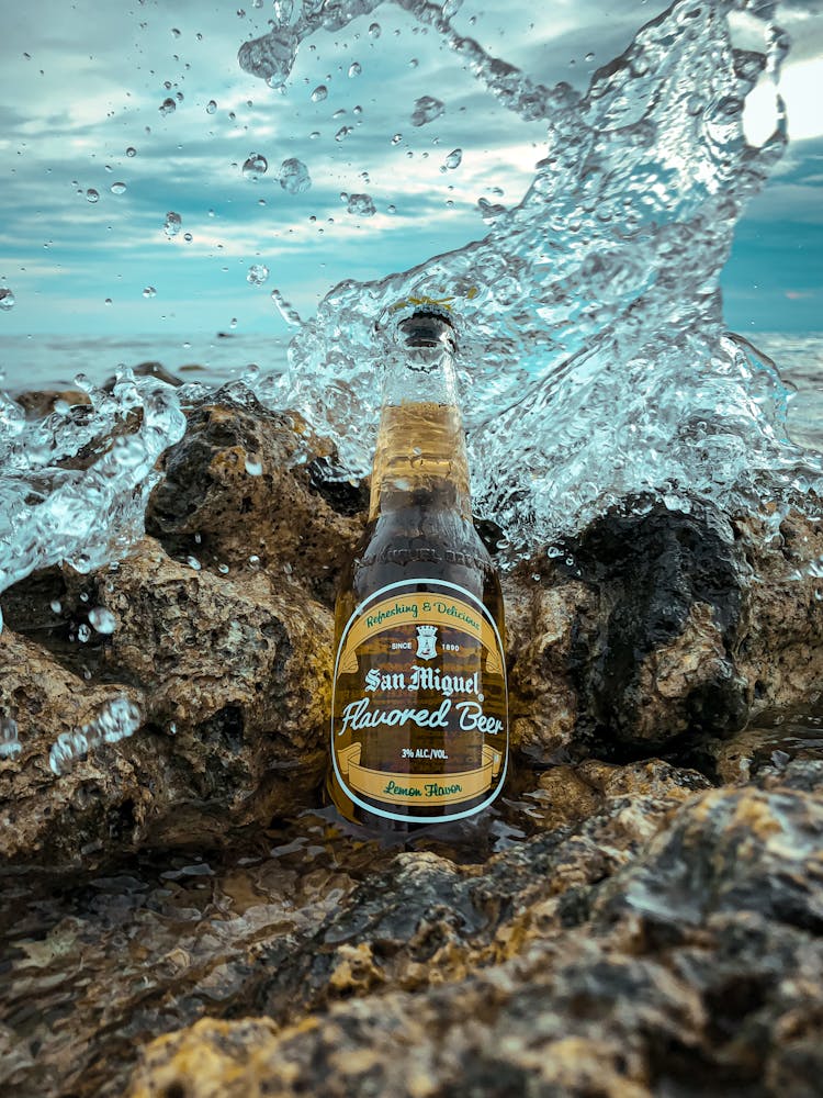 Bottle Of Beer Against Sea Wave