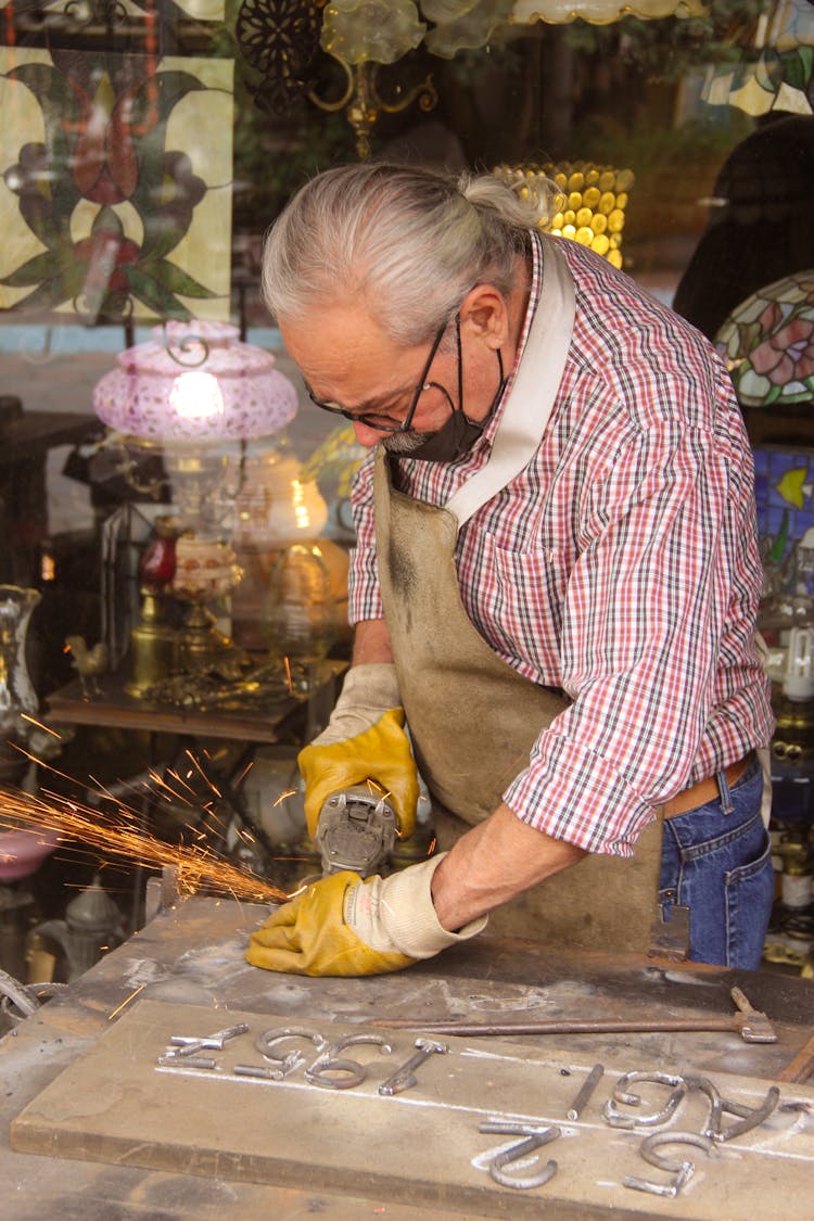 Man Grinding Metal With Sparks