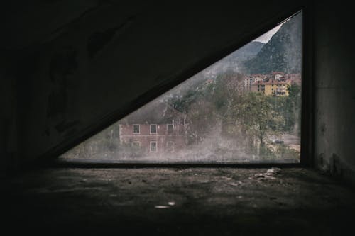 Free Triangle Shape Window in a Weathered Building Stock Photo