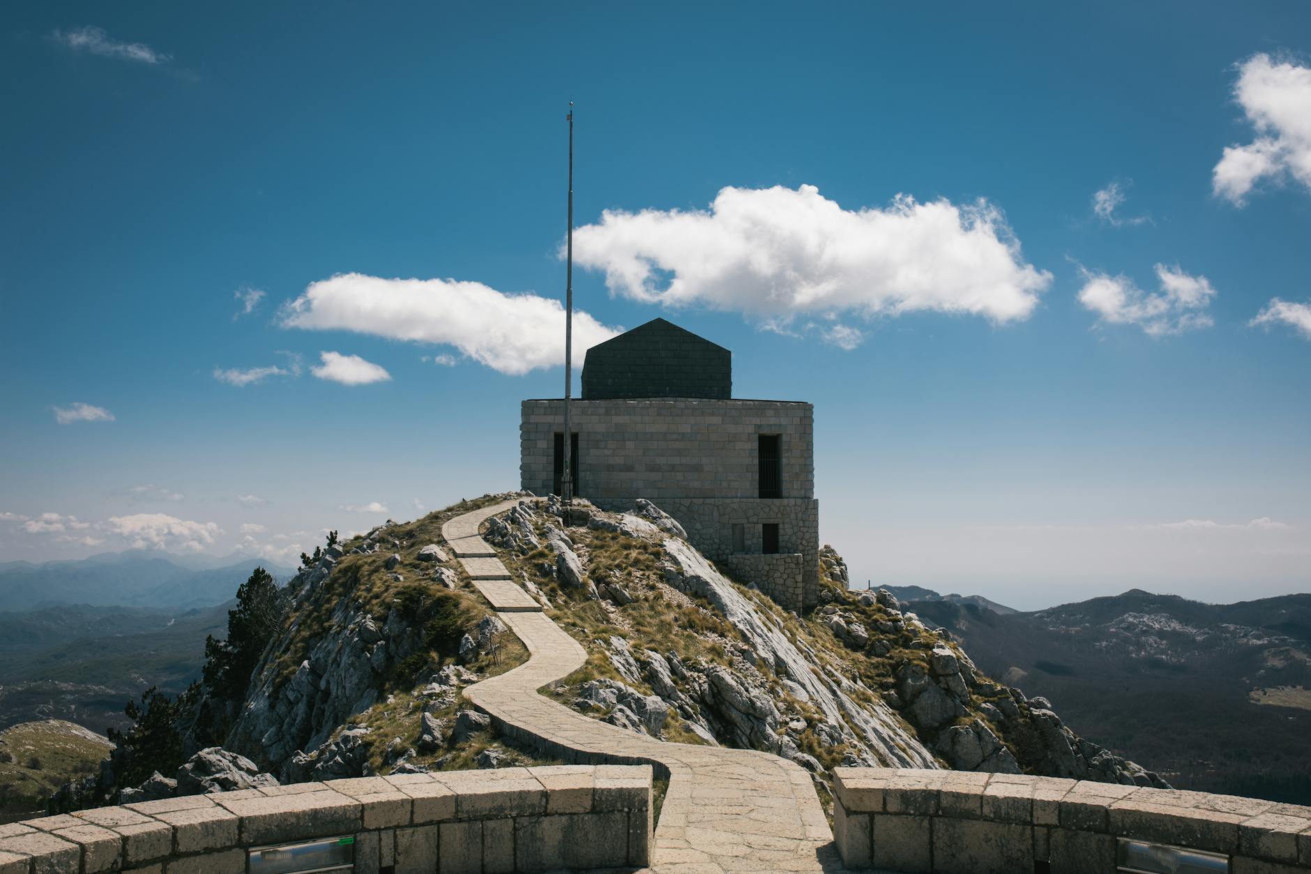 Stone path winding through Lovćen National Park with mountain views