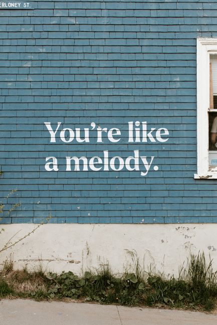 A blue wall with the quote 'You're like a melody' in Dartmouth, Canada.