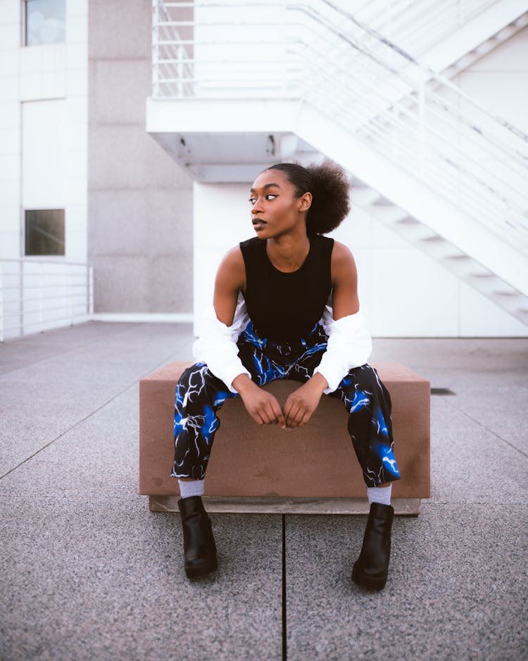 Woman Wearing Black Top And Jeans With Thunder Pattern