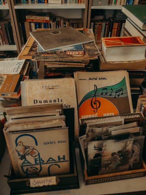 Free A collection of vintage books and records displayed on shelves, evoking a nostalgic and retro feel. Stock Photo
