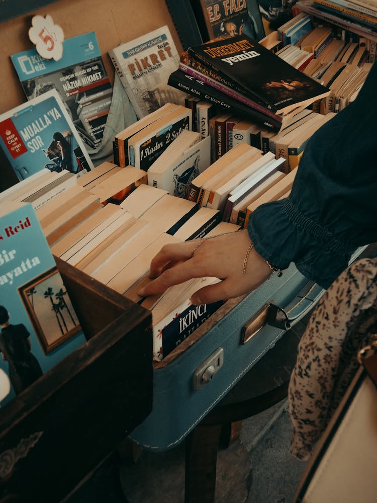 Woman Hand Touching Books In Book Store