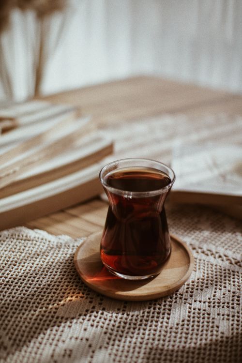 Free A warm, inviting glass of Turkish tea served on a cozy wooden table. Stock Photo