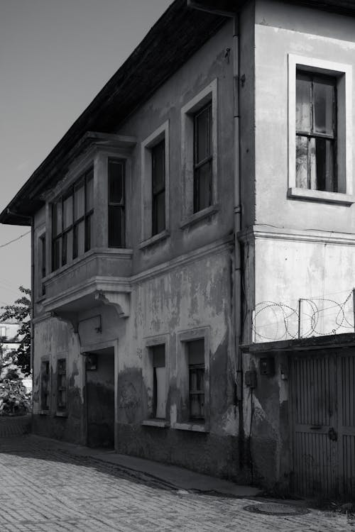 Grayscale Photo of Abandoned Concrete Building